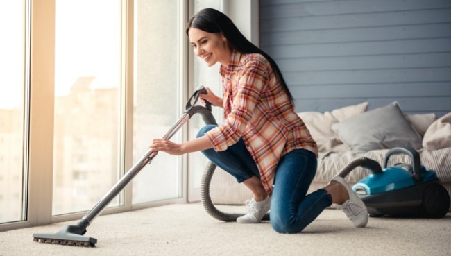 Lady cleaning carpet floor | York Carpetland USA 