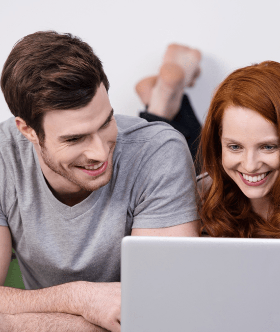 Happy couple with laptop | York Carpetland USA 